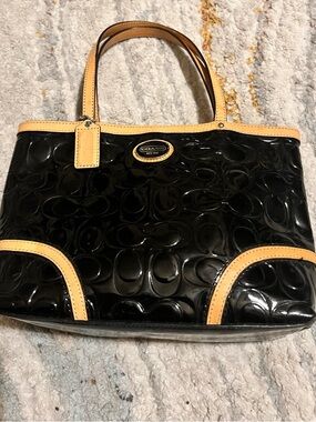 Coach Peyton Black Patent Tote with Tan Trim and Signature Plaque.